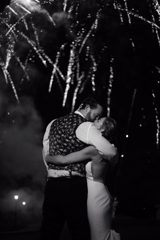 firework wedding photo of bride and groom kissing at their wedding in suffolk virginia -bisoux de lune meagan reily