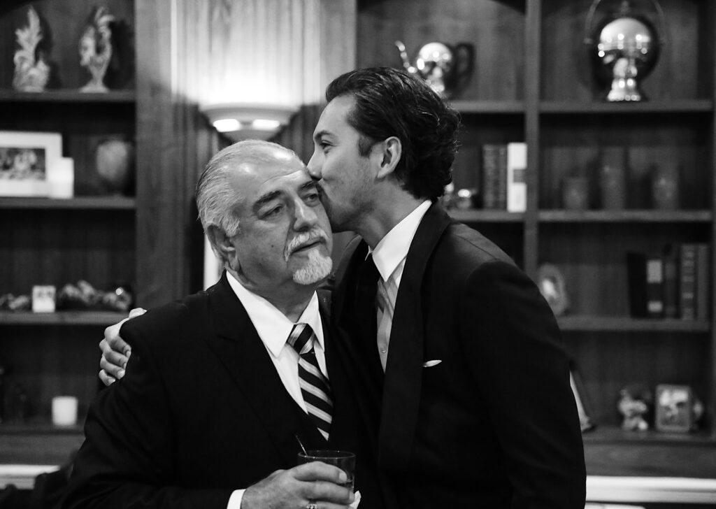 Dad and Son sharing a moment at a wedding - Bisoux De Lune