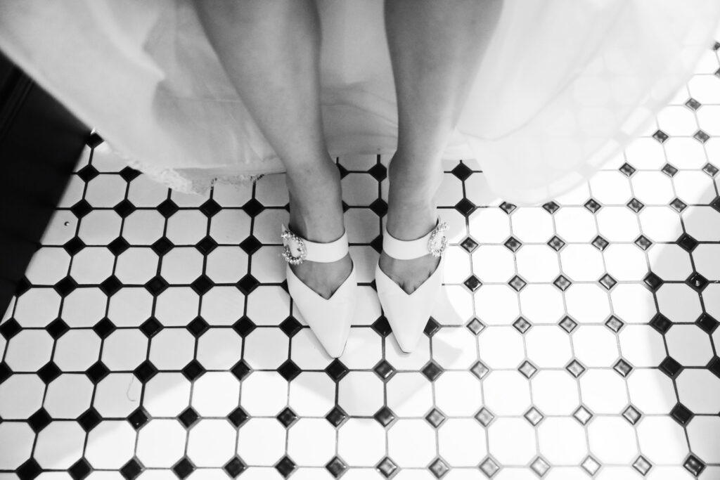 female woman feet white shoes on bathroom flow white with black diamonds - - Bisoux De Lune